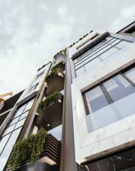 The modern architecture of the façade has a minimalistic approach with simple geometric shapes combined with flower boxes on the terrace of each floor